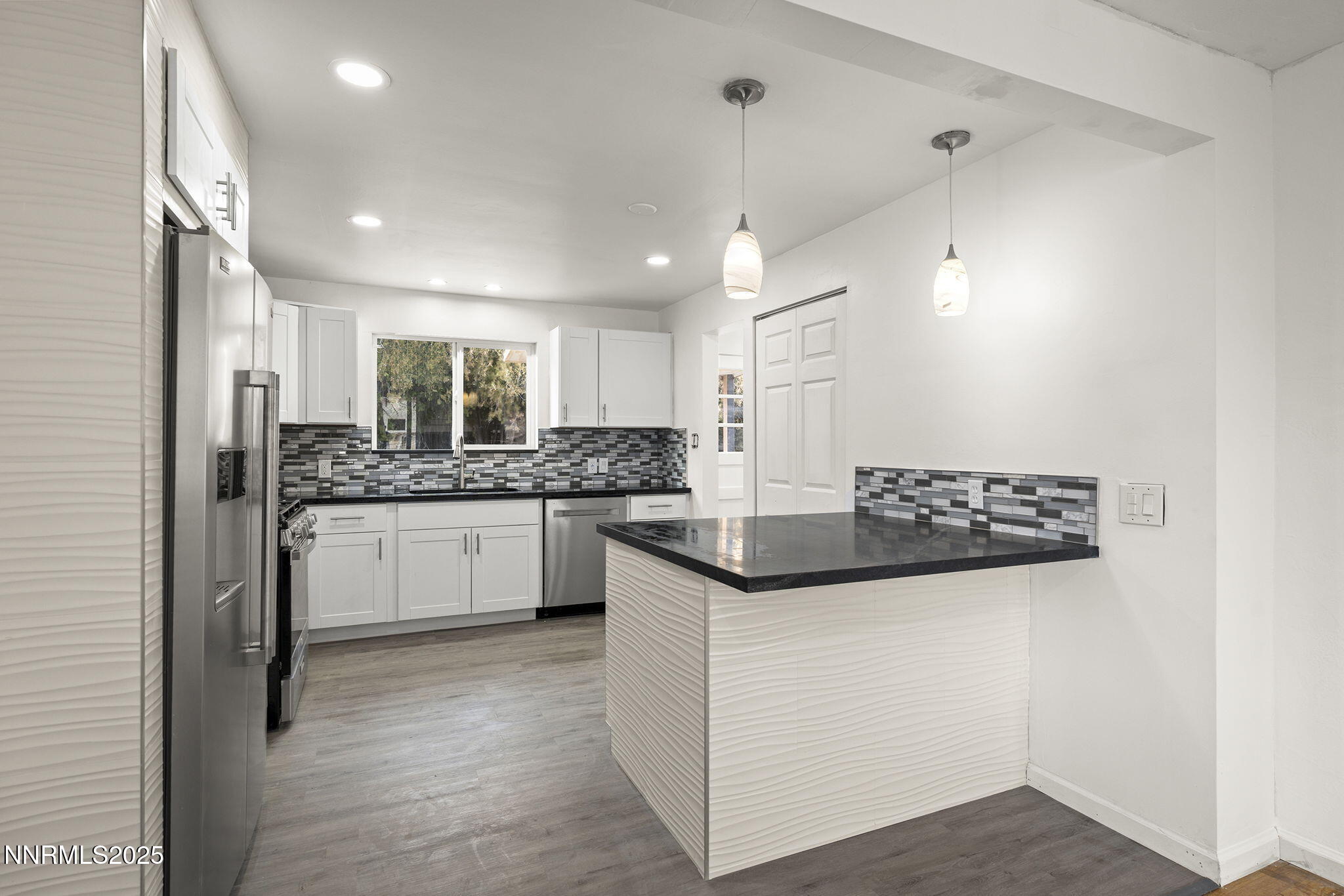 1085 Memory Lane Reno, NV 89509 - Photo 10 of 21 a kitchen with stainless steel appliances kitchen island granite countertop a stove a sink and a refrigerator