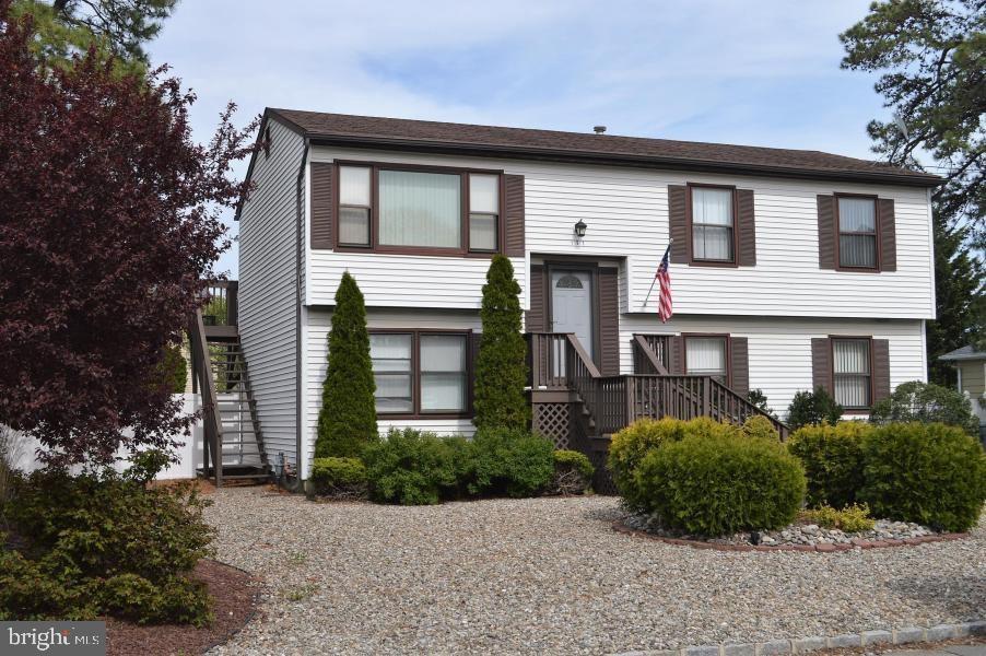 131 Club House Road Brick, NJ 08723 - Photo 2 of 20 a house that has a lot of windows in it