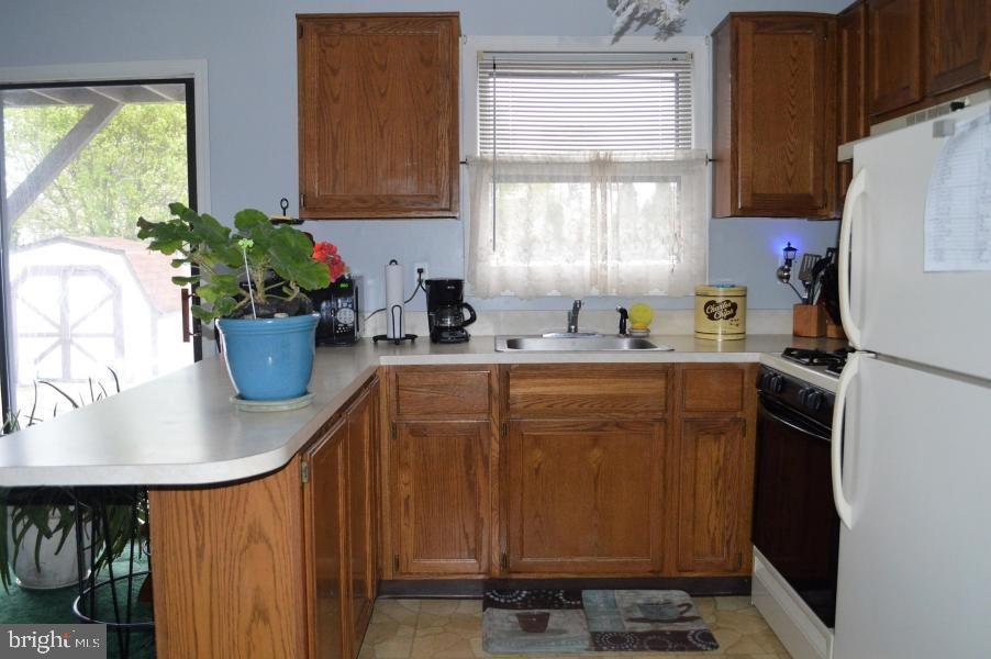 131 Club House Road Brick, NJ 08723 - Photo 14 of 20 a kitchen with a refrigerator and a sink