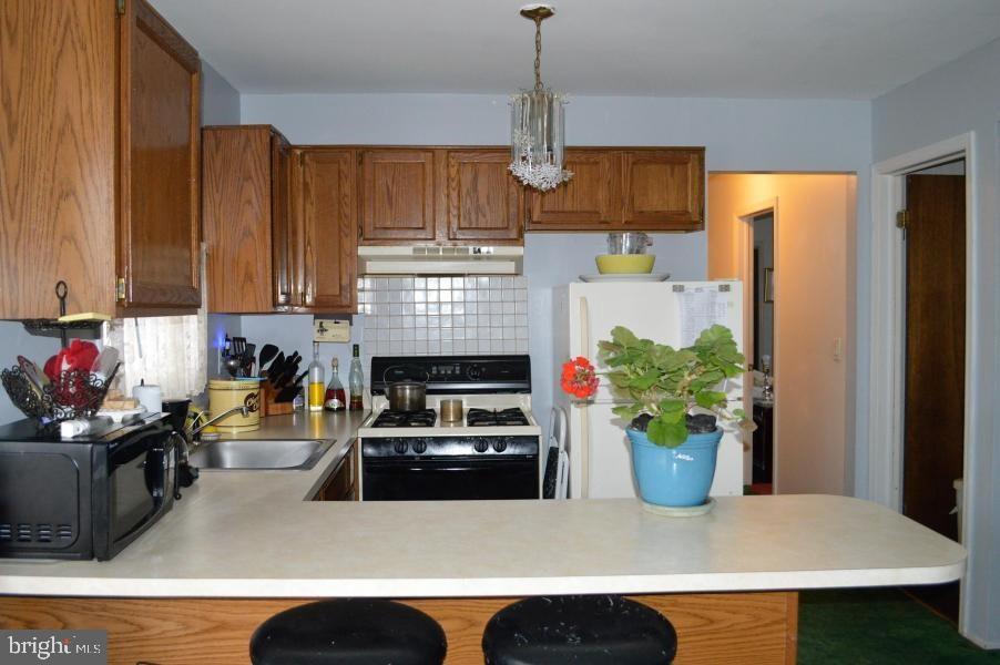 131 Club House Road Brick, NJ 08723 - Photo 15 of 20 a kitchen with stainless steel appliances granite countertop a refrigerator a stove and a sink