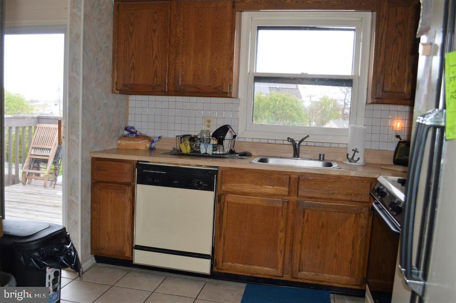 131 Club House Road Brick, NJ 08723 - Photo 3 of 20 a kitchen with stainless steel appliances a sink stove and cabinets