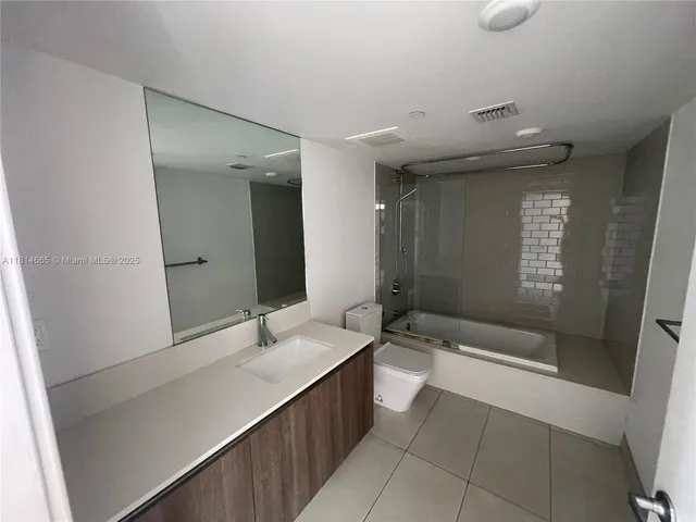 a bathroom with a bathtub and a sink