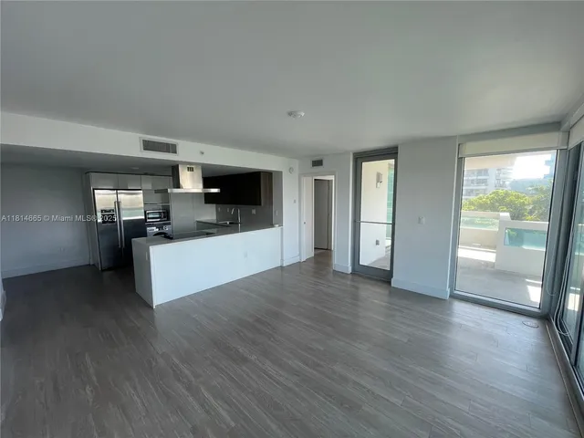 a view of a kitchen with a sink and a refrigerator
