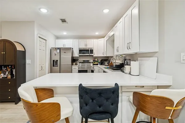 a kitchen with a refrigerator stove and microwave