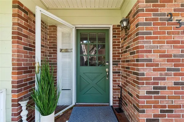 a view of a door and brick wall