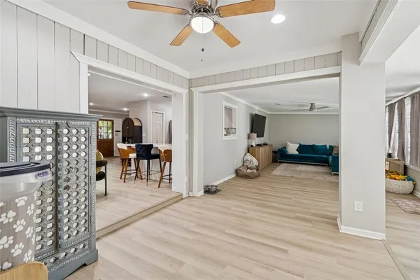a view of a kitchen with furniture and wooden floor
