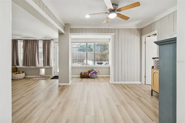 a living room with furniture a flat screen tv and a window