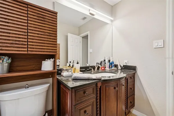 a backyard of a house with plants and palm trees