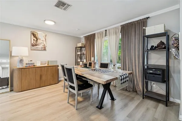 a view of a dining room with furniture and window