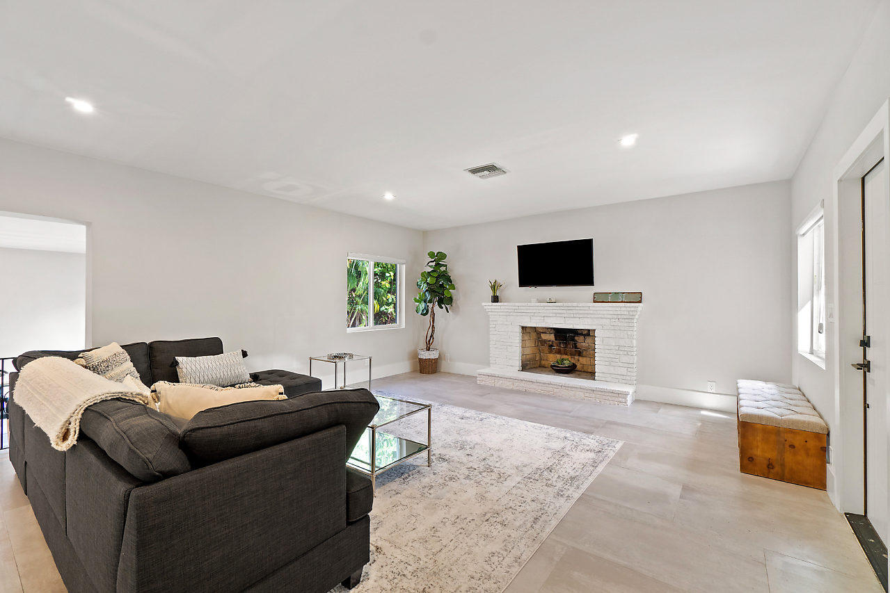 110 Avocado Road Delray Beach, FL 33444 - Photo 8 of 44 a living room with furniture and a fireplace