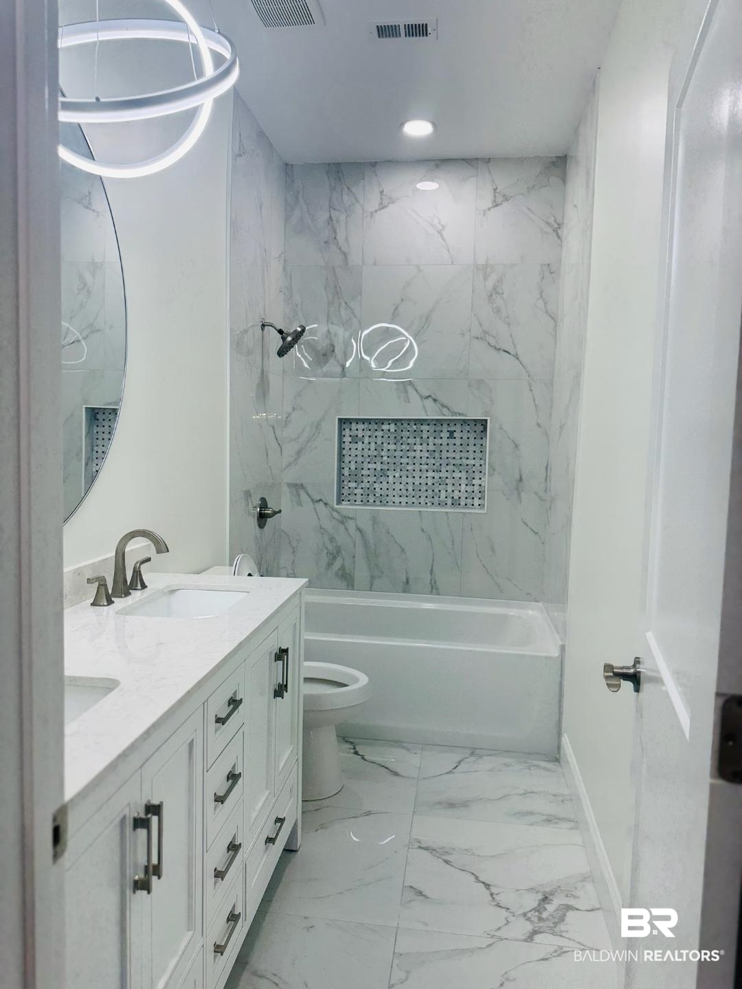 2663 Demetropolis Road Mobile, AL 36693 - Photo 19 of 26 Full bathroom with double vanity, tub / shower combination, marble finish flooring, and recessed lighting