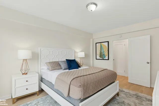 a bedroom with a bed and a night stand