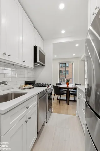 a kitchen with sink cabinets and microwave