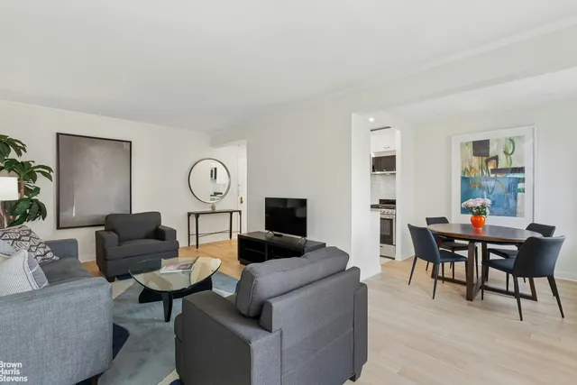 a living room with furniture a rug and a flat screen tv
