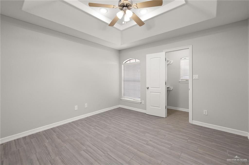 213 South 49th Street, Unit 2 McAllen, TX 78501 - Photo 12 of 23 wooden floor in an empty room with a window