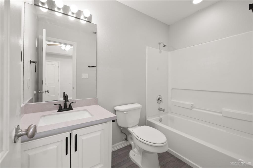 213 South 49th Street, Unit 2 McAllen, TX 78501 - Photo 13 of 23 a bathroom with a sink a toilet and shower