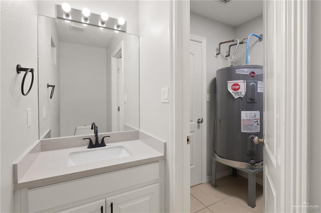 213 South 49th Street, Unit 2 McAllen, TX 78501 - Photo 15 of 23 a bathroom with a sink and mirror