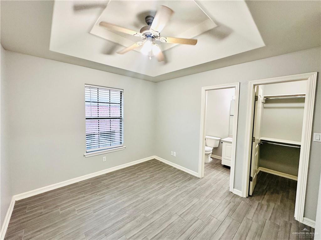 213 South 49th Street, Unit 2 McAllen, TX 78501 - Photo 7 of 23 wooden floor in an empty room with a window