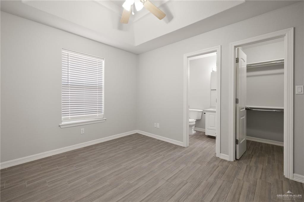 213 South 49th Street, Unit 2 McAllen, TX 78501 - Photo 10 of 23 wooden floor in an empty room with a window