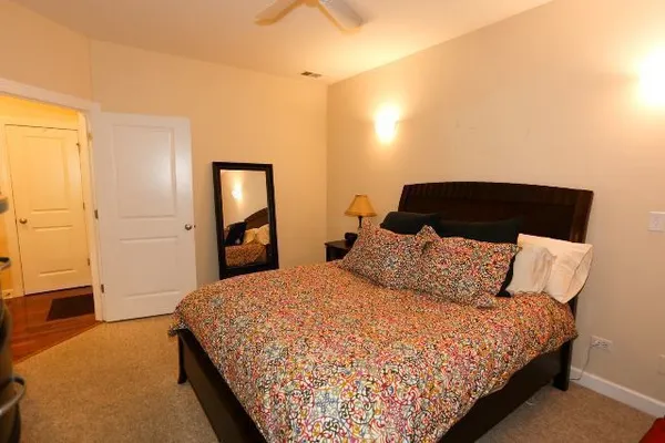 a bedroom with a bed and a night stand