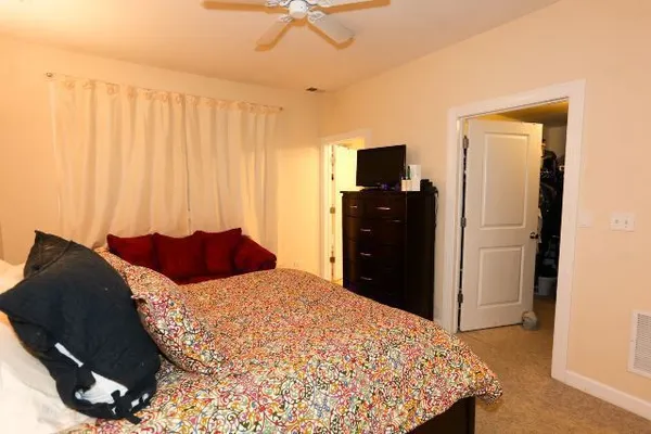 a bedroom with a bed and a television