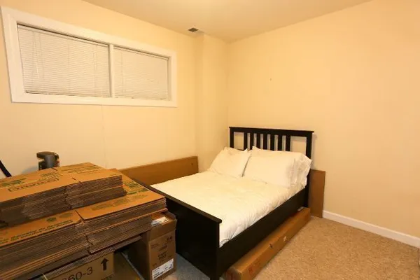 a bedroom with a bed and a dresser