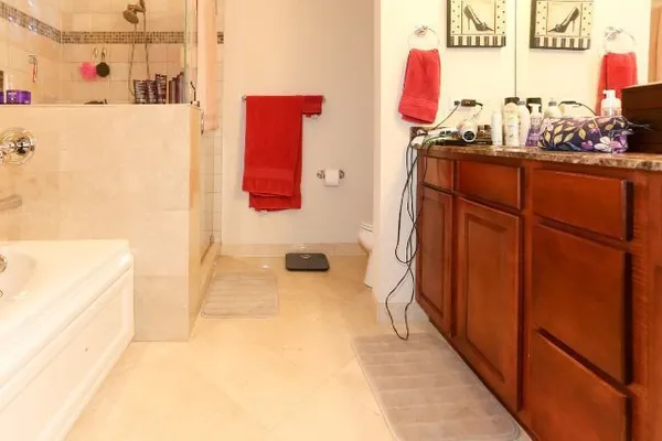 a bathroom with a tub sink and mirror