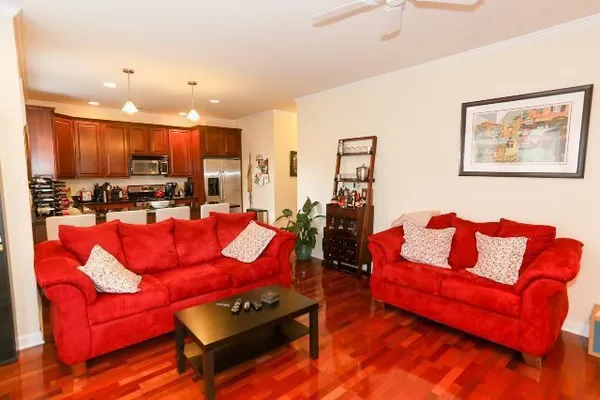 a living room with furniture kitchen view and a couch
