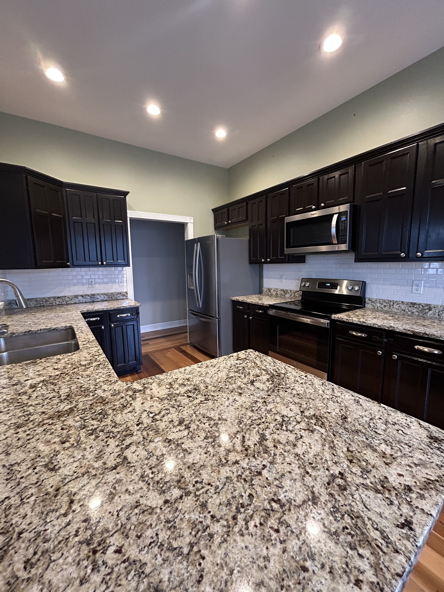 834 Blakemore Road Dickson, TN 37055 - Photo 11 of 26 a kitchen with stainless steel appliances kitchen island granite countertop a refrigerator and a sink