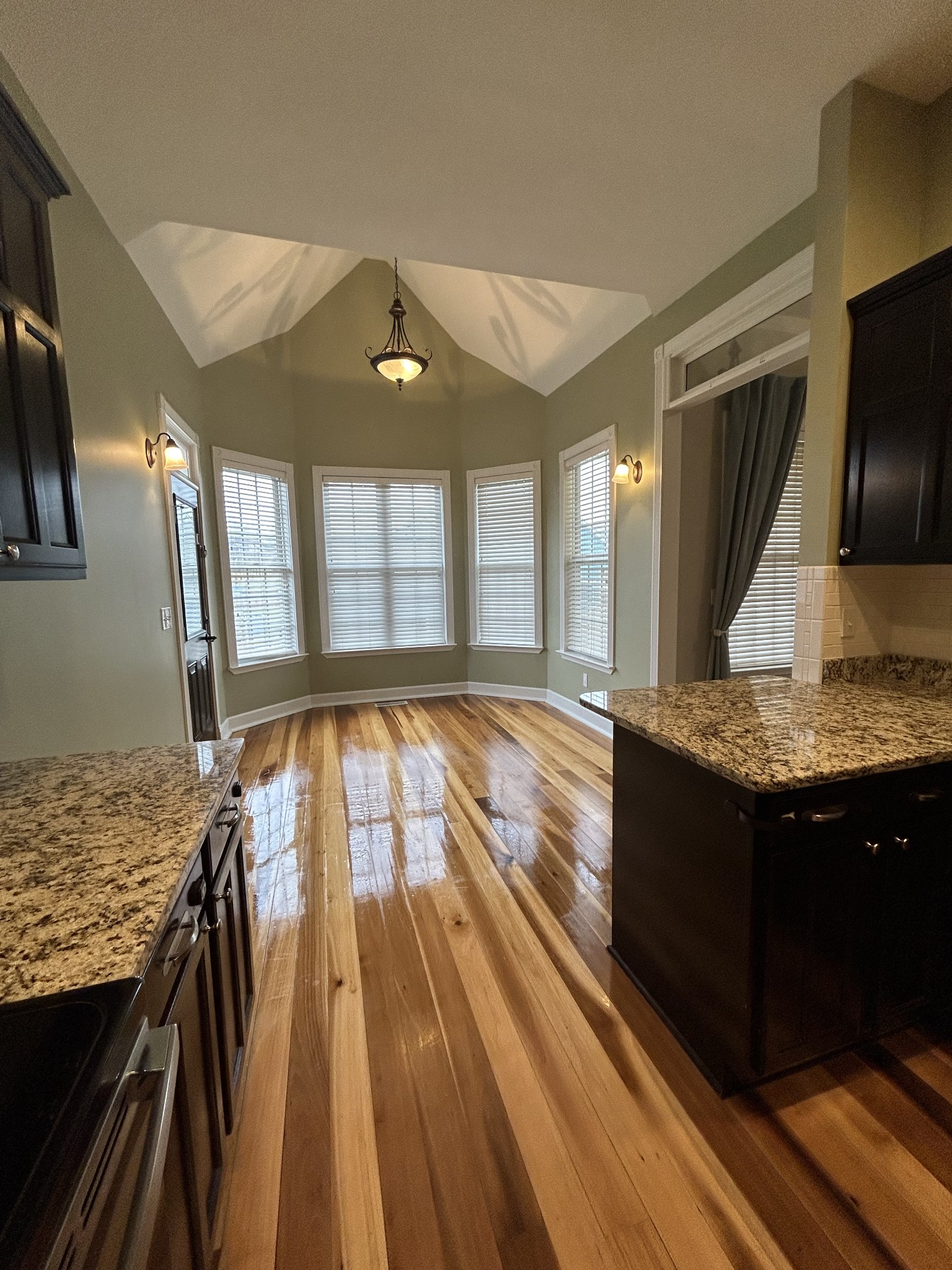 834 Blakemore Road Dickson, TN 37055 - Photo 16 of 26 a view of a kitchen with kitchen island wooden floor and a sink