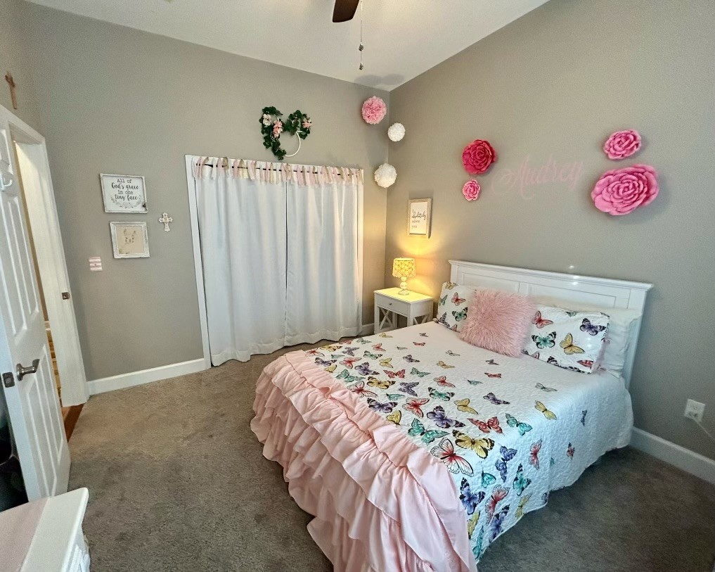 834 Blakemore Road Dickson, TN 37055 - Photo 21 of 26 a bedroom with a bed and a chandelier