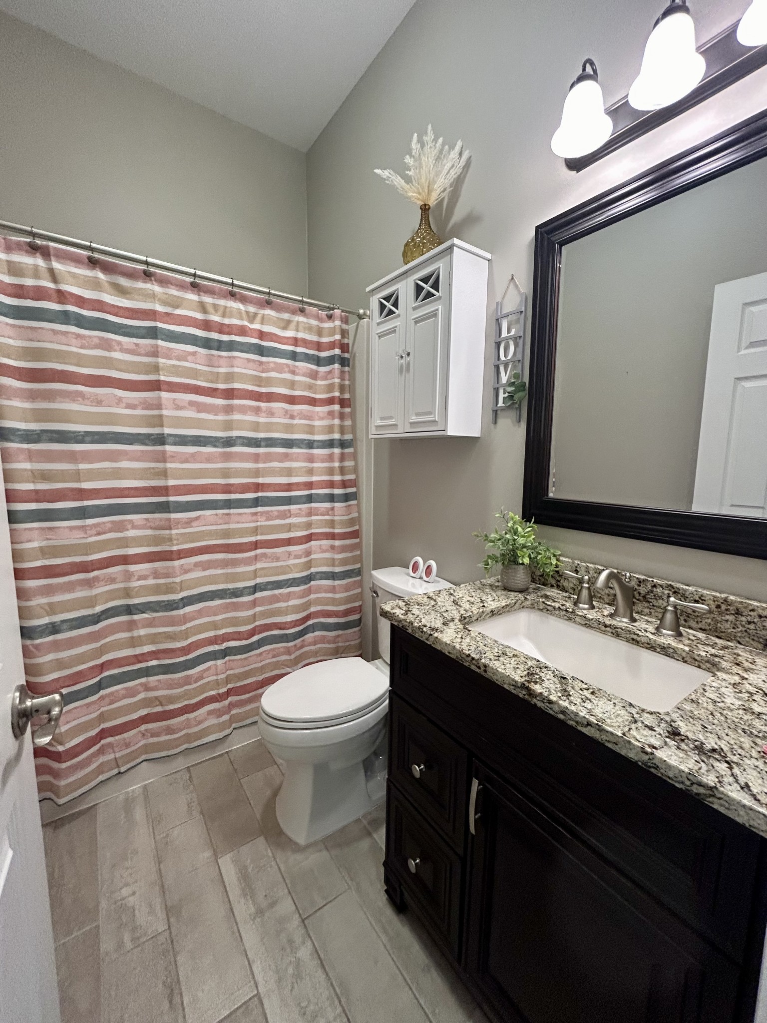 834 Blakemore Road Dickson, TN 37055 - Photo 23 of 26 a bathroom with a granite countertop toilet sink and mirror