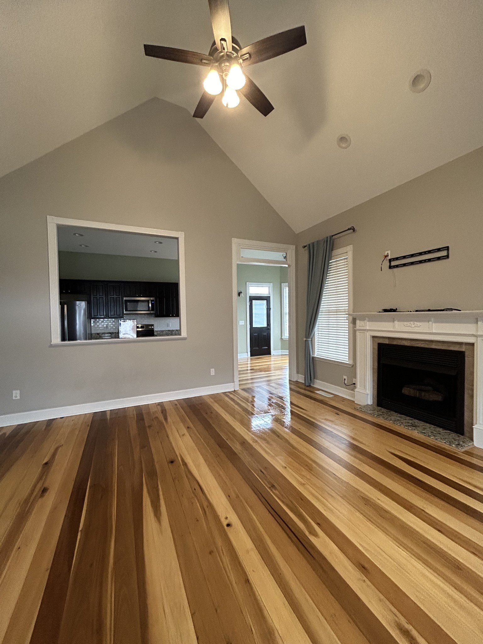834 Blakemore Road Dickson, TN 37055 - Photo 5 of 26 a view of an empty room with wooden floor fireplace and a window