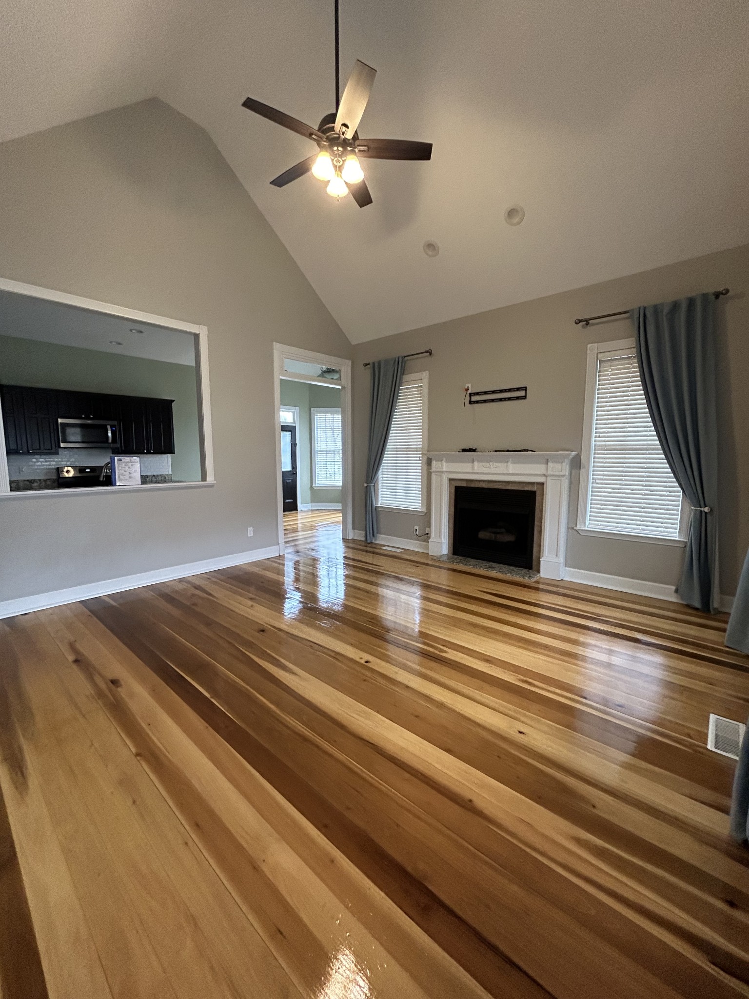 834 Blakemore Road Dickson, TN 37055 - Photo 6 of 26 an empty room with wooden floor fireplace and windows