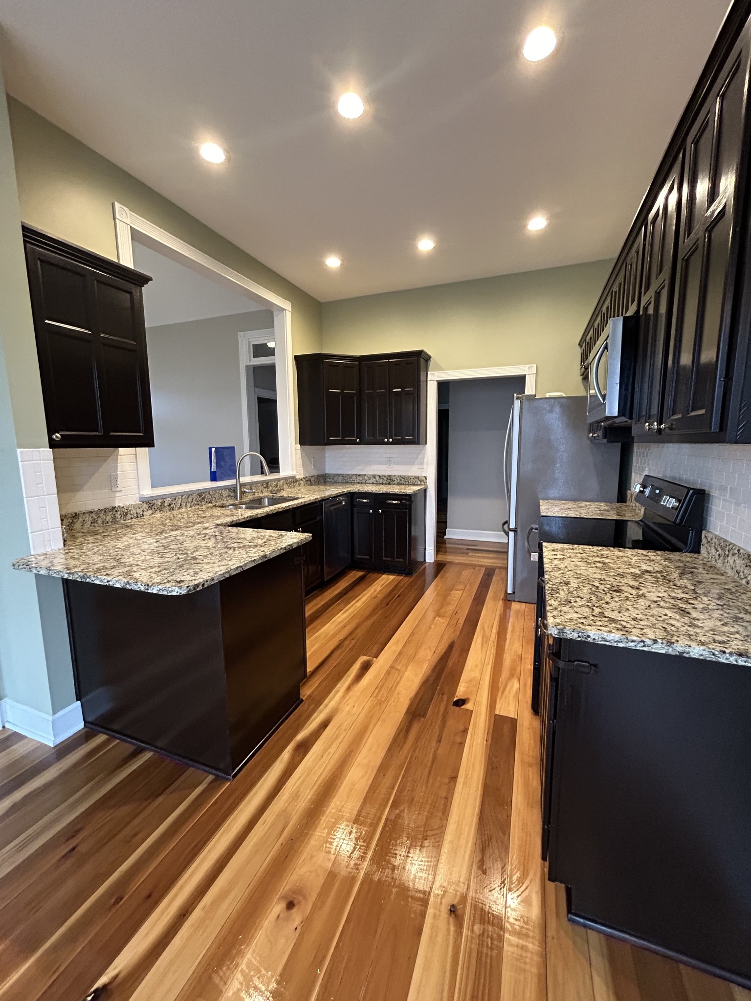 834 Blakemore Road Dickson, TN 37055 - Photo 10 of 26 a large kitchen with kitchen island a sink stove and cabinets