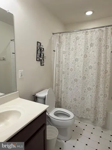 a bathroom with a toilet a sink and shower