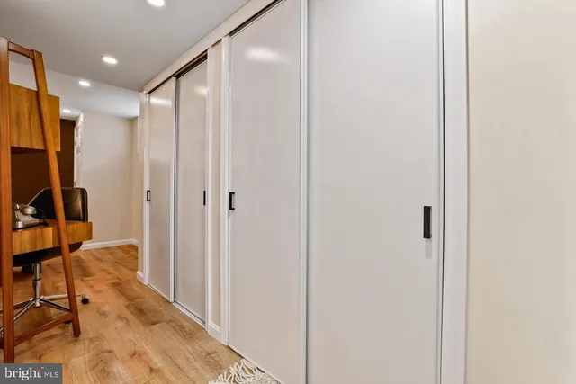 a view of a hallway with a bathroom
