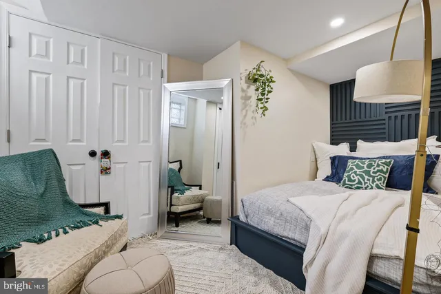 a bedroom with a bed couch and window