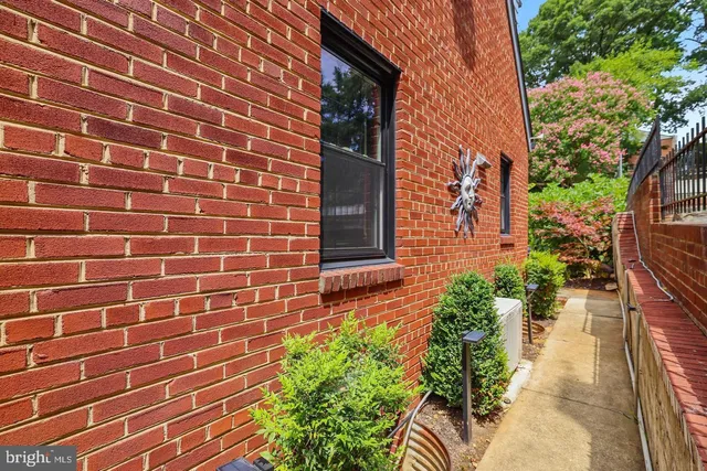 a view of a brick house with a flower plants