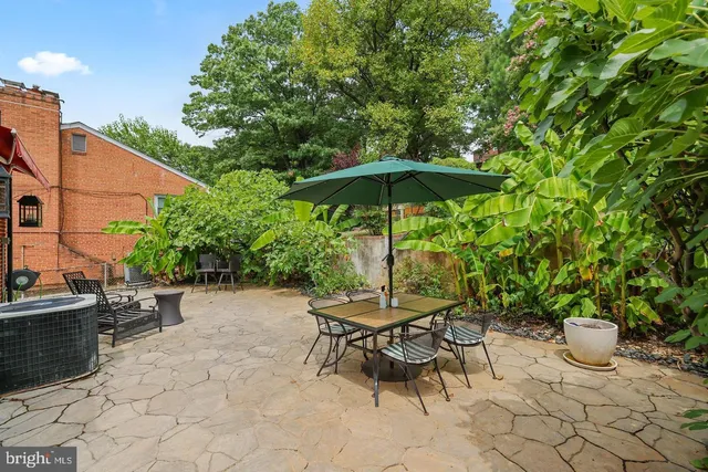 a view of building with cars parked across