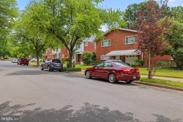 a front view of a house with a garden and mountain view
