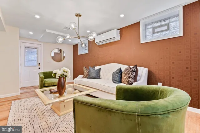 a living room with furniture and a chandelier