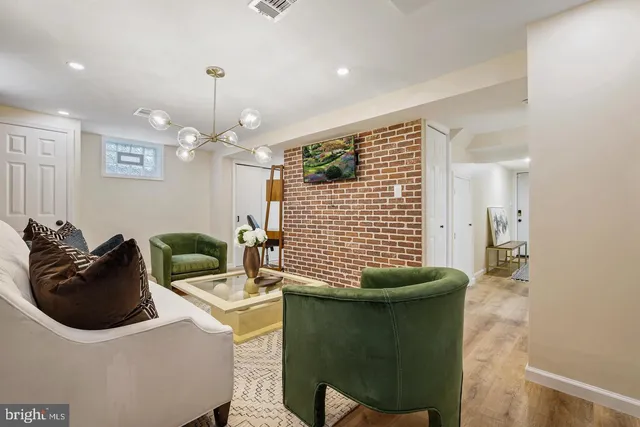 a bathroom with a sink a mirror and potted plants