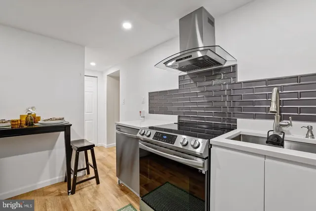 a kitchen with a stove and a sink