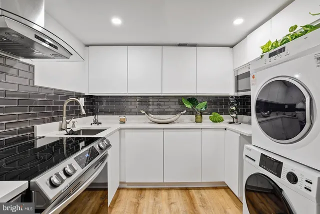 a utility room with sink dryer and washer