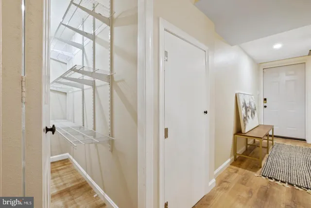 a view of a livingroom with a flesh wooden floor and front door