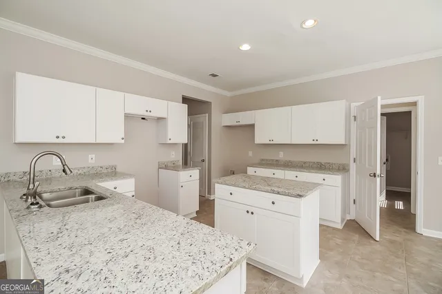 a kitchen with a sink stove and cabinets