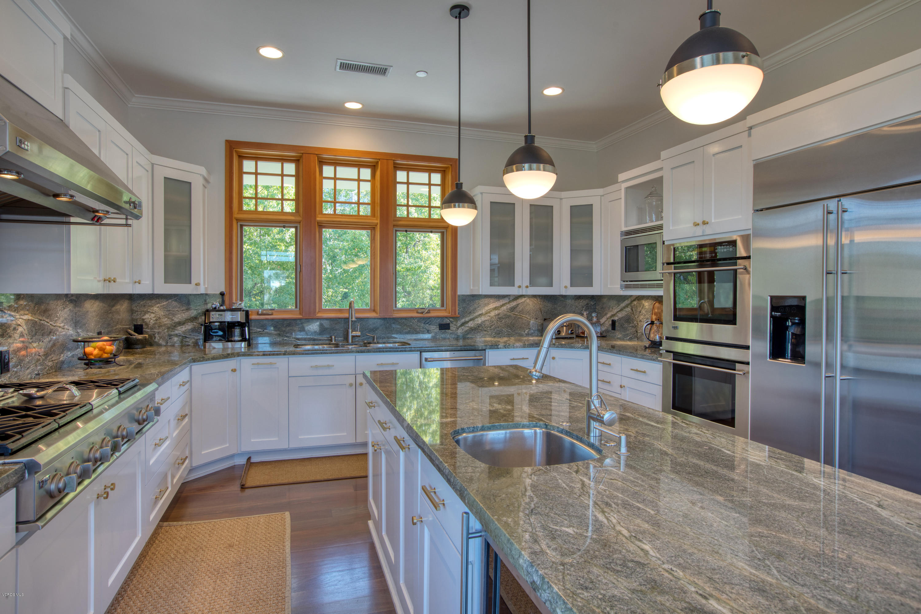 55 Upper Lake Road Westlake Village, CA 91361 - Photo 15 of 40 a large kitchen with kitchen island a large counter space a sink and stainless steel appliances