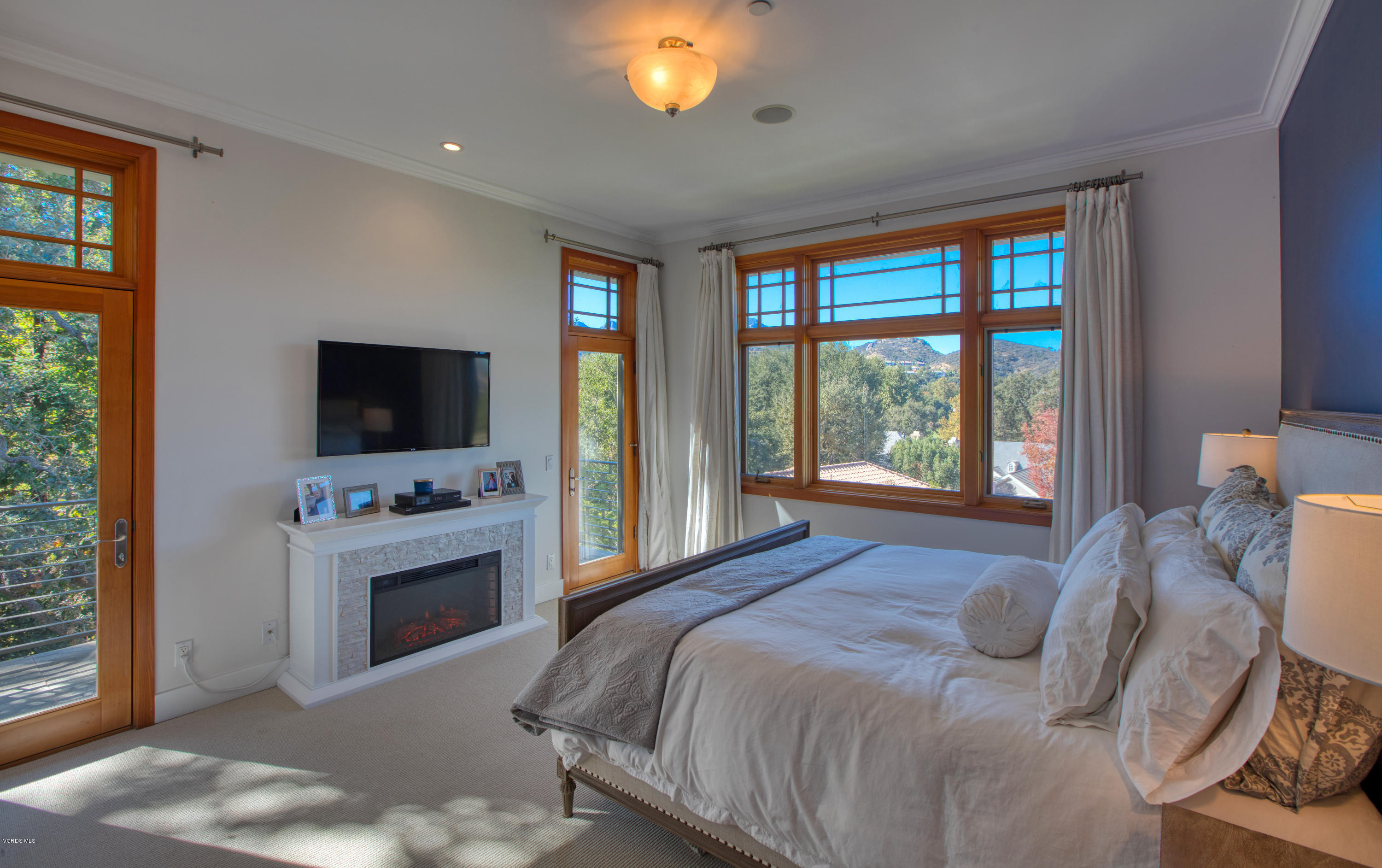 55 Upper Lake Road Westlake Village, CA 91361 - Photo 9 of 40 a bedroom with a bed and a flat screen tv