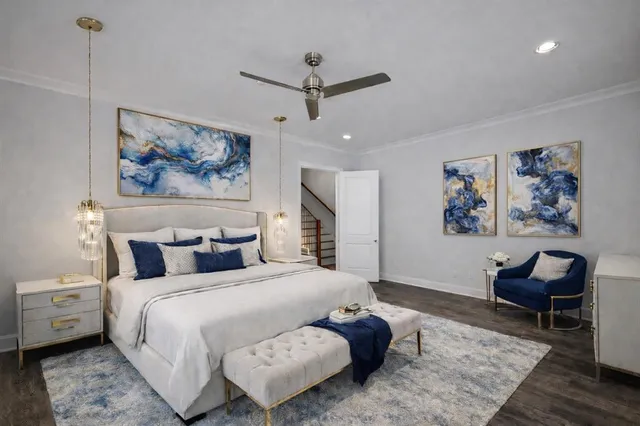 a bedroom with a bed and a painting on the wall